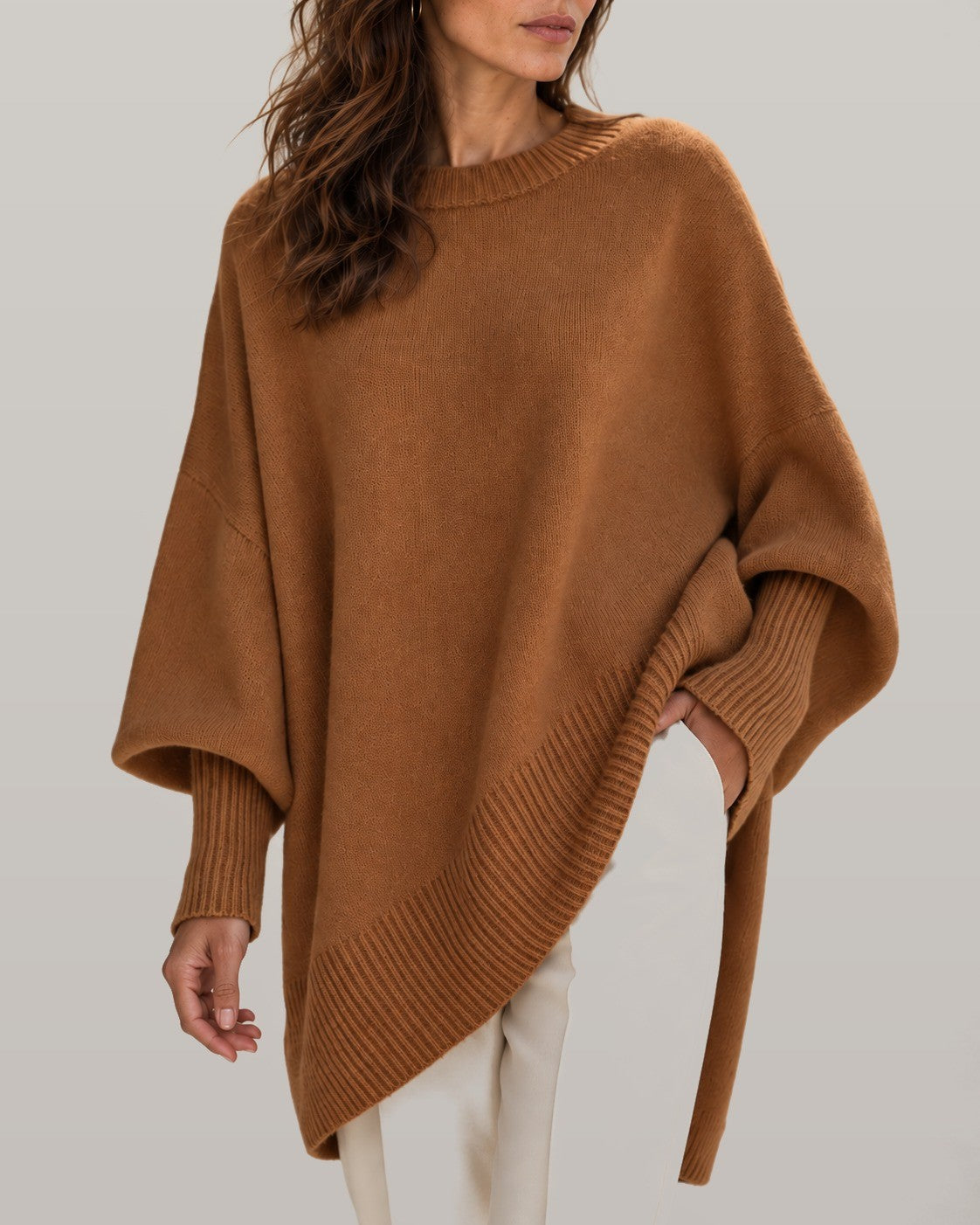 Draped asymmetric knit poncho in brown, close-up detail