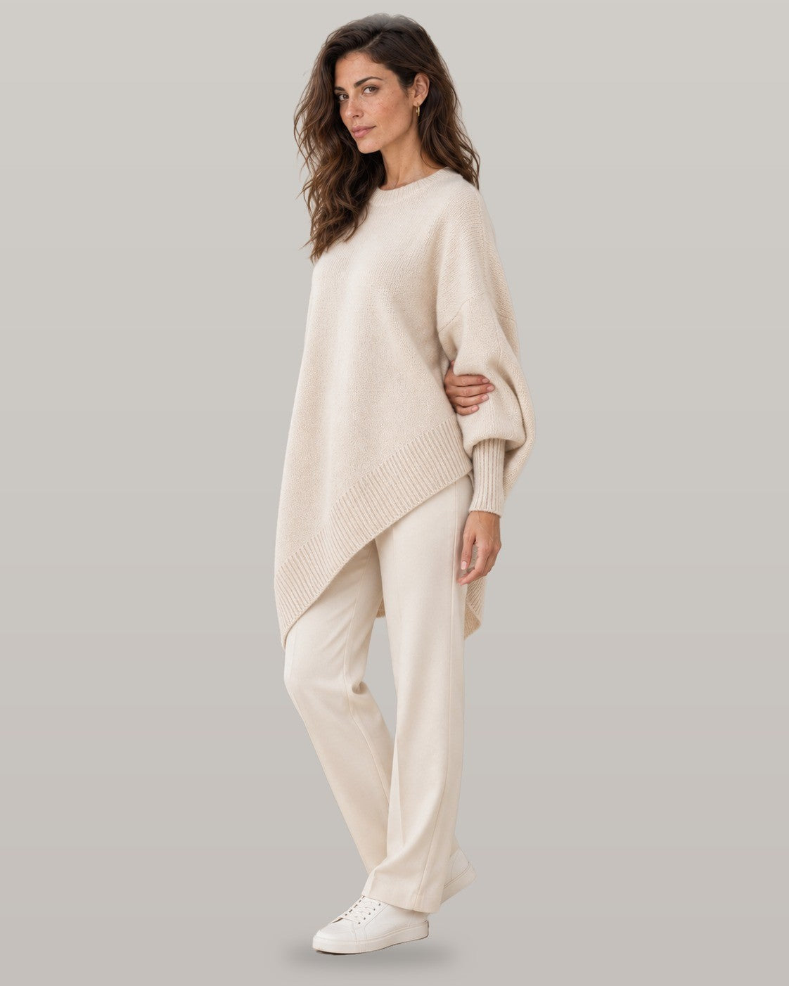 Draped asymmetric knit poncho in beige, full-length view