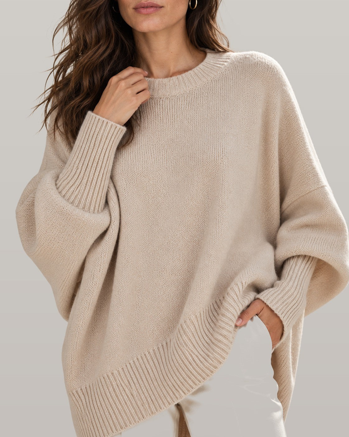 Draped asymmetric knit poncho in beige, close-up detail
