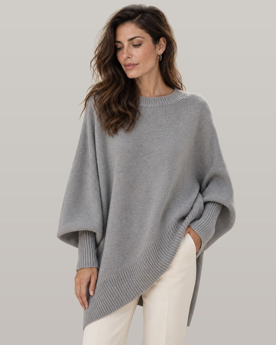 Draped asymmetric knit poncho in gray, front view