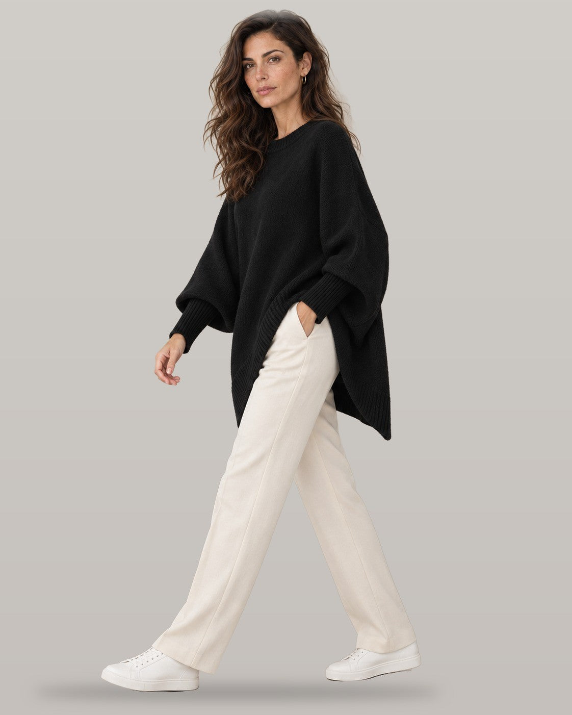 Draped asymmetric knit poncho in black, full-length view