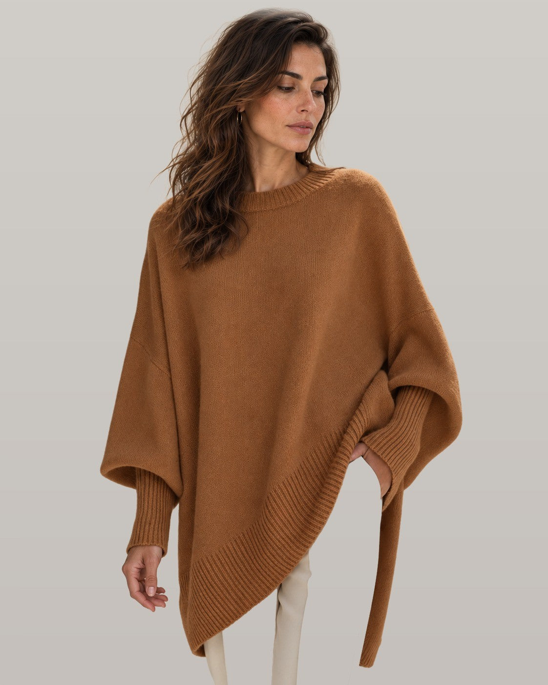 Draped asymmetric knit poncho in brown, front view