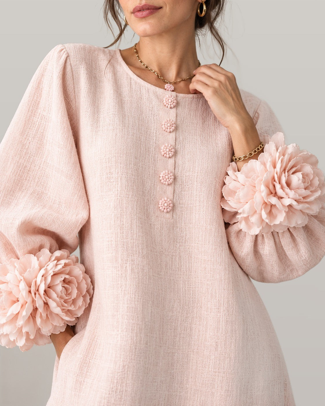 Midi dress with rose-cuff sleeves in pink, close-up detail