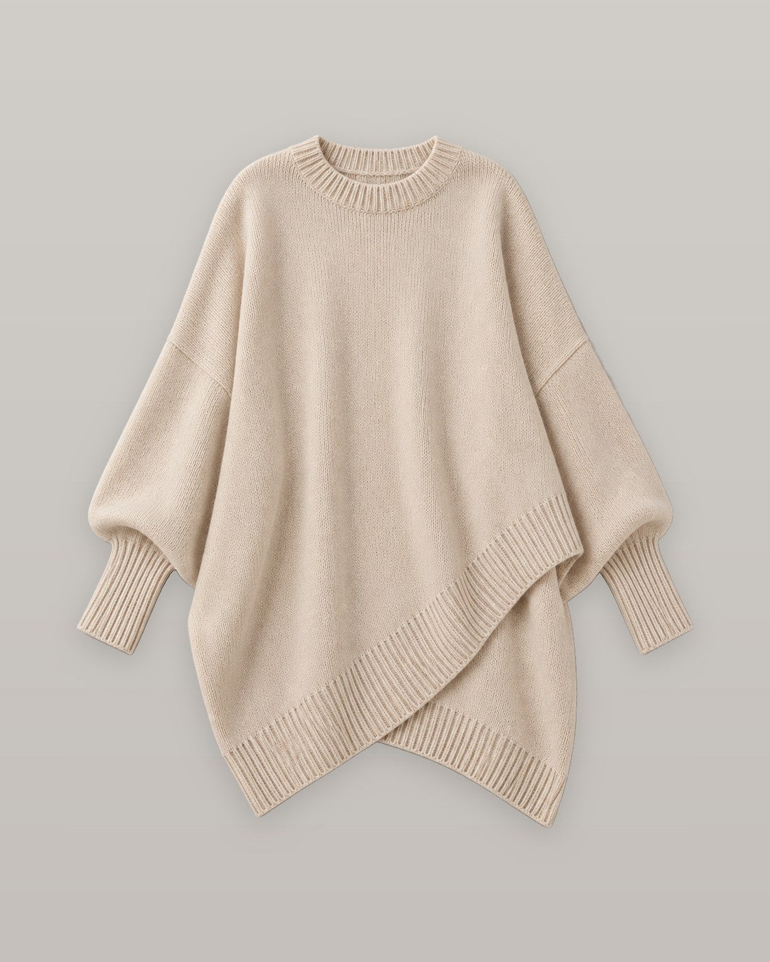 Draped asymmetric knit poncho in beige, flat lay