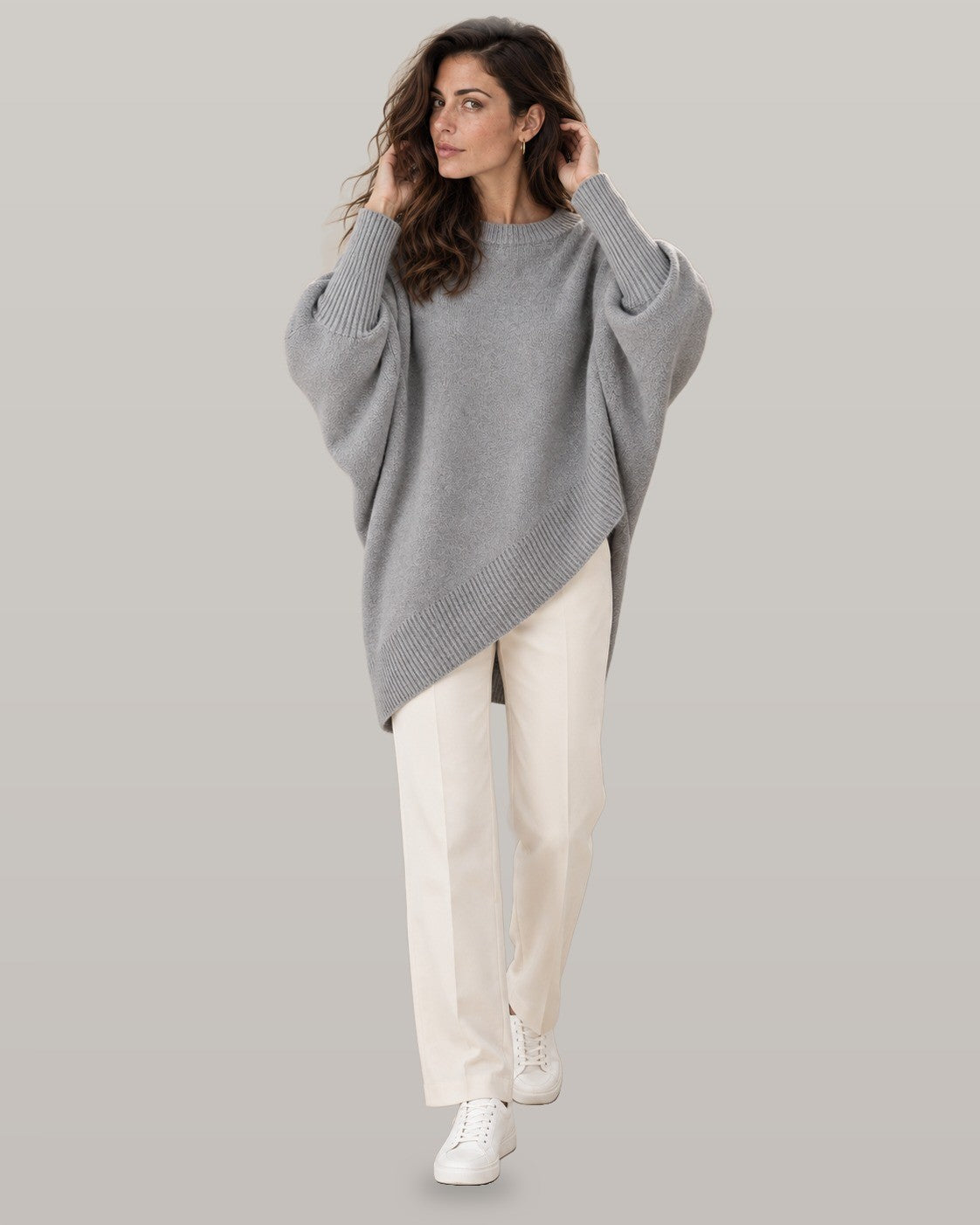 Draped asymmetric knit poncho in gray, full-length view