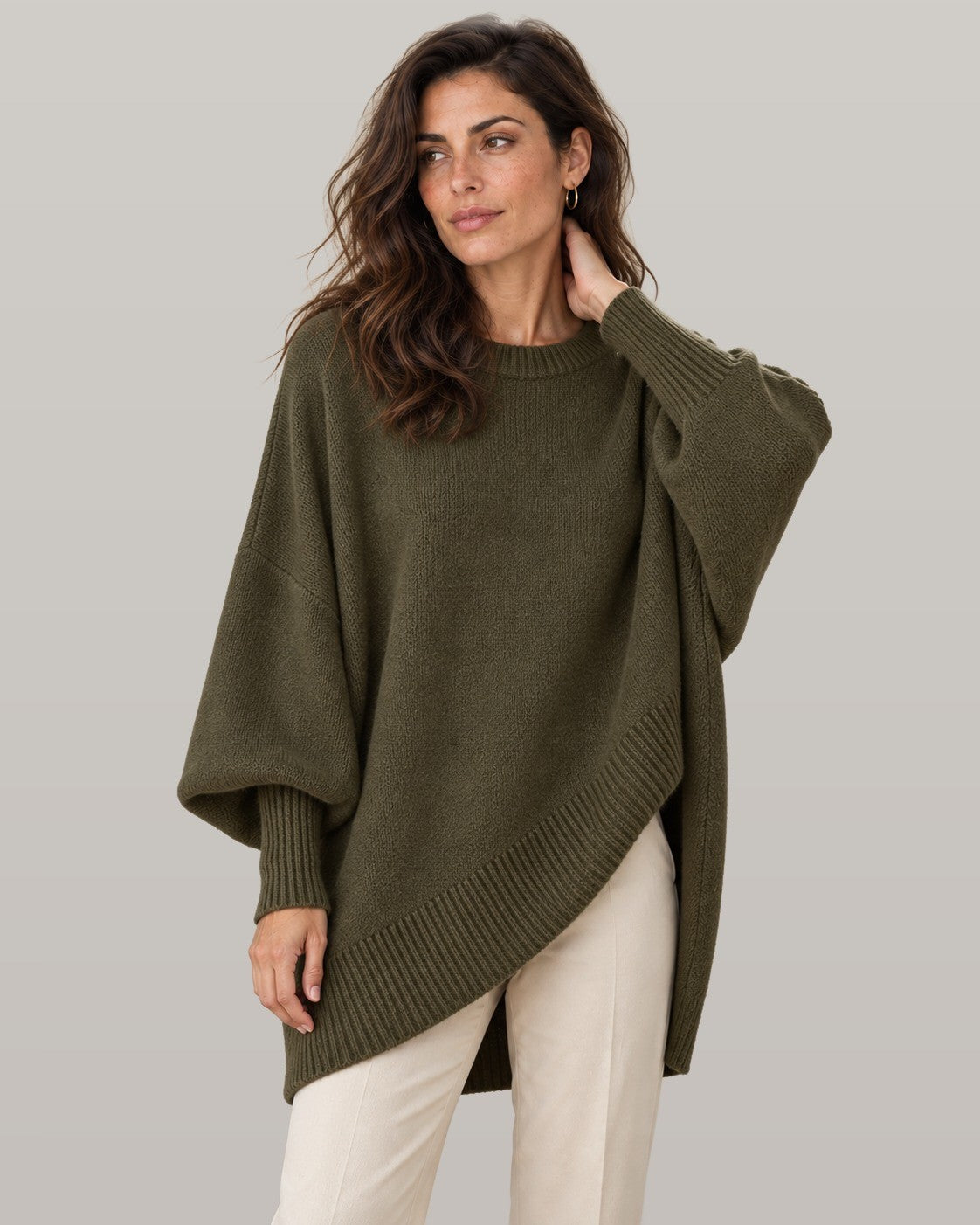 Draped asymmetric knit poncho in dark green, front view