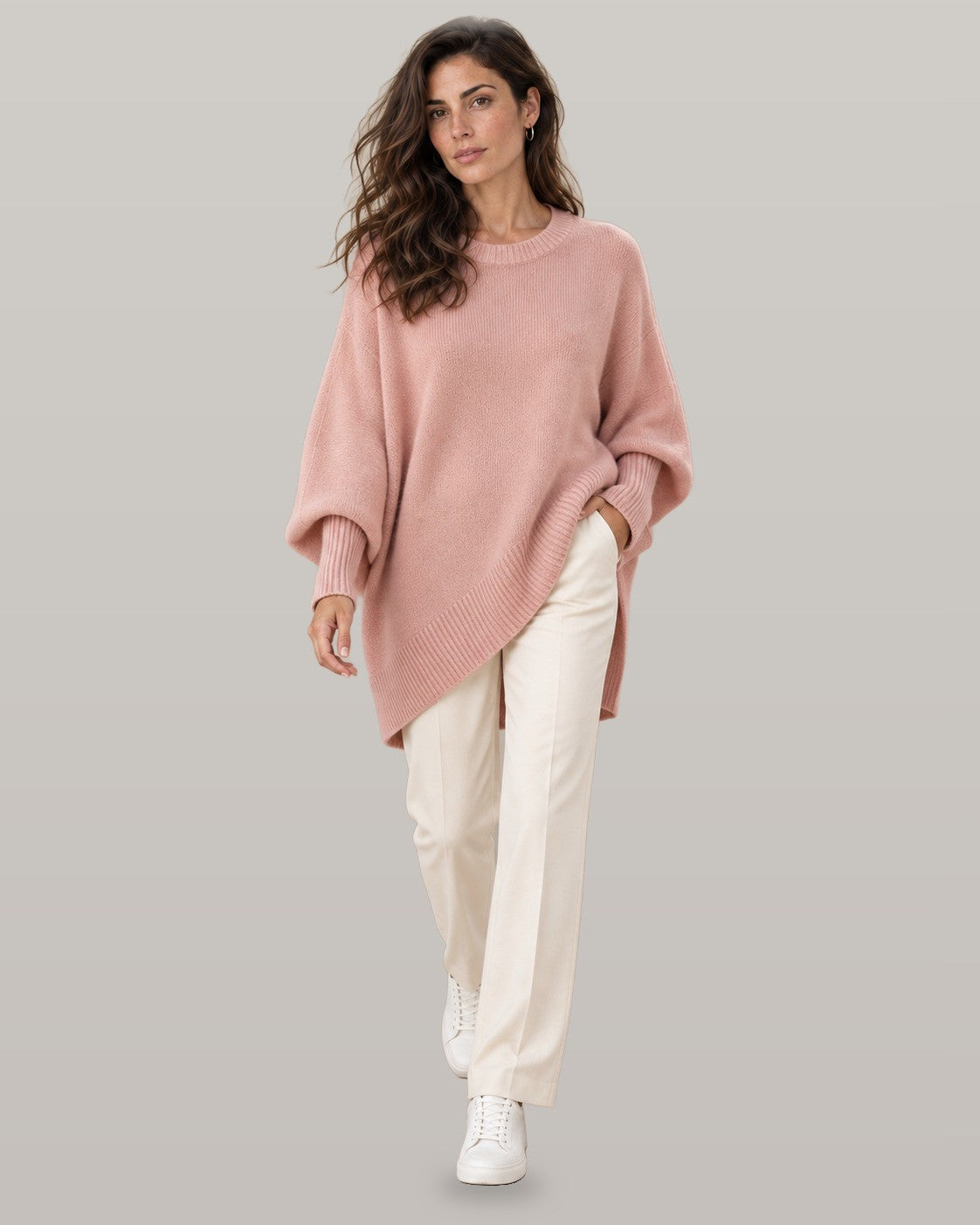 Draped asymmetric knit poncho in pink, full-length view