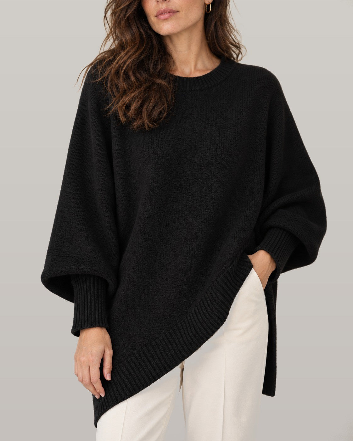 Draped asymmetric knit poncho in black, close-up detail